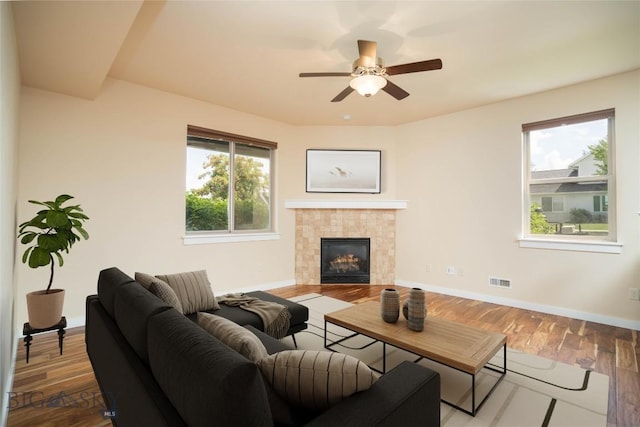 56 Koch Peak Ct, Bozeman, MT 59718 - living room featuring wood finished floors, a fireplace, and a ceiling fan