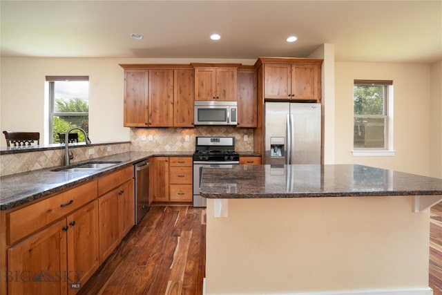 56 Koch Peak Ct, Bozeman, MT 59718 - kitchen featuring stainless steel appliances, dark wood finished floors, recessed lighting, backsplash, and dark stone counters