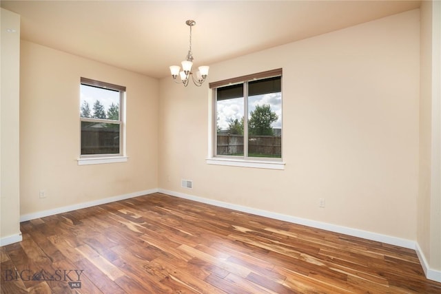 56 Koch Peak Ct, Bozeman, MT 59718 - unfurnished room with a chandelier and wood finished floors