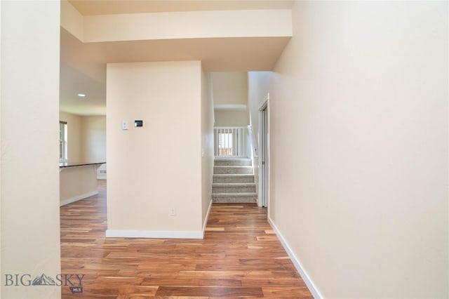 56 Koch Peak Ct, Bozeman, MT 59718 - corridor with plenty of natural light, light wood finished floors, stairway, and recessed lighting