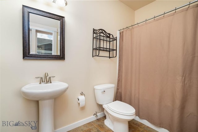 56 Koch Peak Ct, Bozeman, MT 59718 - full bathroom with baseboards and curtained shower