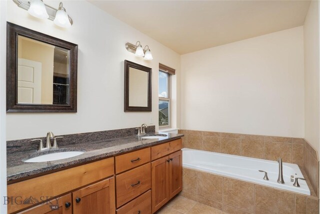 56 Koch Peak Ct, Bozeman, MT 59718 - full bathroom featuring a bath, double vanity, and tile patterned flooring