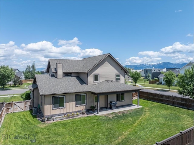 56 Koch Peak Ct, Bozeman, MT 59718 - rear view of property featuring board and batten siding, roof with shingles, a patio, and a fenced backyard