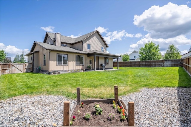56 Koch Peak Ct, Bozeman, MT 59718 - rear view of house with board and batten siding, a fenced backyard, a shingled roof, a patio area, and a chimney