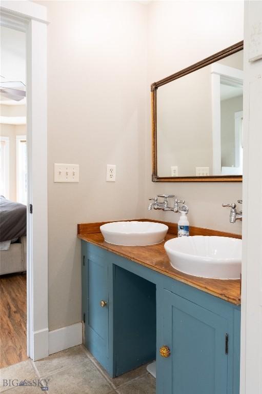 911 N Aster, Bozeman, MT 59718 - ensuite bathroom featuring double vanity and baseboards