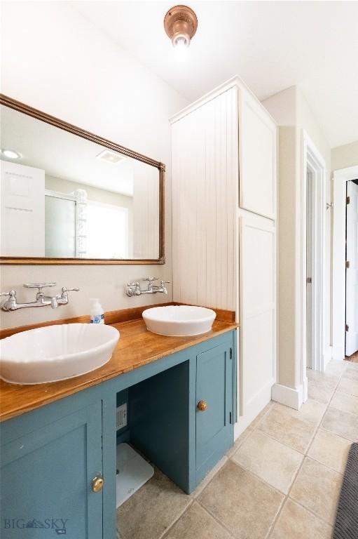 911 N Aster, Bozeman, MT 59718 - bathroom featuring double vanity and tile patterned floors
