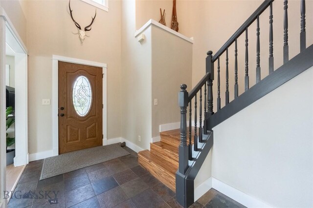 911 N Aster, Bozeman, MT 59718 - foyer entrance featuring stone tile floors, a towering ceiling, and stairway