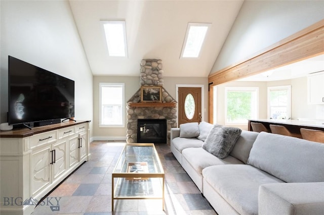 911 N Aster, Bozeman, MT 59718 - living room featuring healthy amount of natural light, a stone fireplace, and high vaulted ceiling