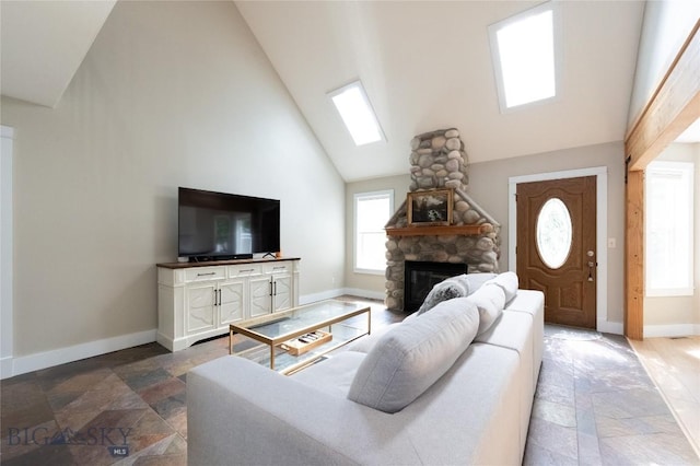 911 N Aster, Bozeman, MT 59718 - living area with stone tile floors, high vaulted ceiling, and a fireplace