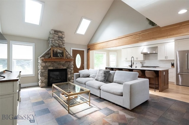 911 N Aster, Bozeman, MT 59718 - living area with high vaulted ceiling, a stone fireplace, and recessed lighting