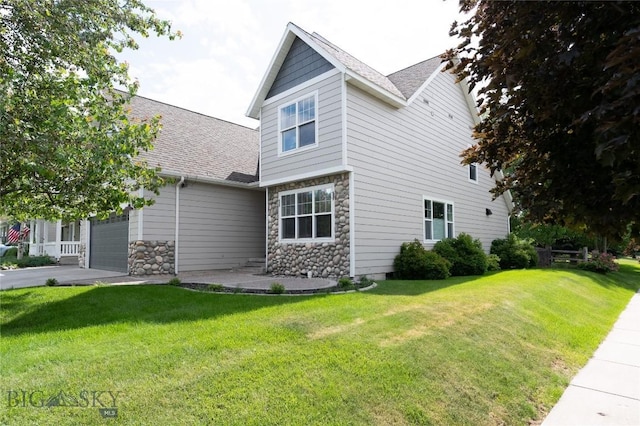 911 N Aster, Bozeman, MT 59718 - view of side of property with stone siding, a lawn, a garage, and roof with shingles