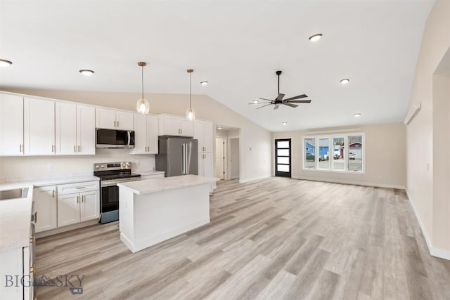 2305 S Colorado, Butte, MT 59701 - kitchen featuring appliances with stainless steel finishes, vaulted ceiling, ceiling fan, a kitchen island, and white cabinets