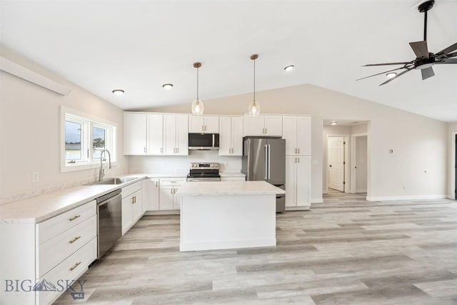 2305 S Colorado, Butte, MT 59701 - kitchen featuring stainless steel appliances, vaulted ceiling, a kitchen island, white cabinetry, and light wood finished floors