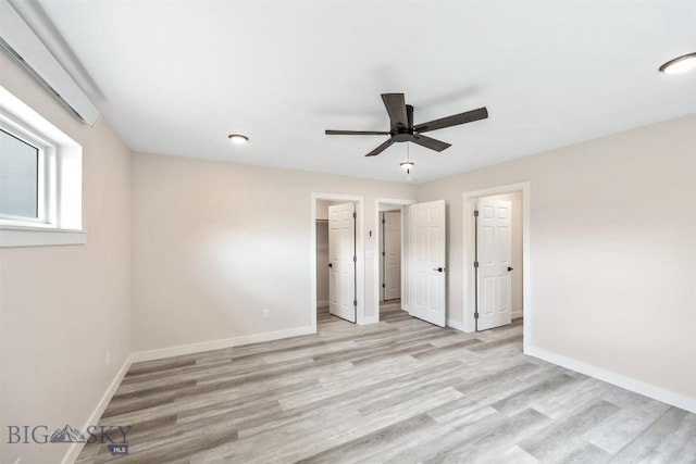 2305 S Colorado, Butte, MT 59701 - unfurnished bedroom with light wood-style floors, a spacious closet, and ceiling fan