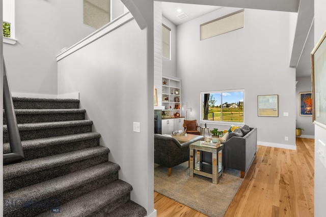 85 Riparian Way, Bozeman, MT 59718 - stairs with a high ceiling, wood finished floors, a fireplace, and arched walkways