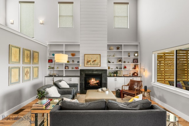 85 Riparian Way, Bozeman, MT 59718 - living area with a high ceiling, wood finished floors, and a fireplace