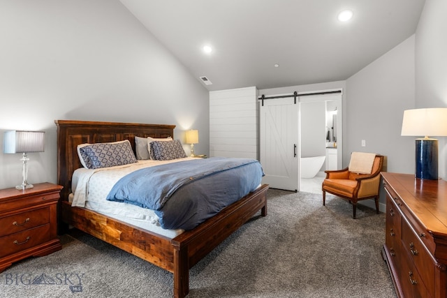 85 Riparian Way, Bozeman, MT 59718 - bedroom with lofted ceiling, a barn door, dark carpet, recessed lighting, and ensuite bath