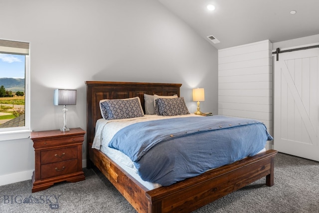 85 Riparian Way, Bozeman, MT 59718 - carpeted bedroom with lofted ceiling, a barn door, and recessed lighting