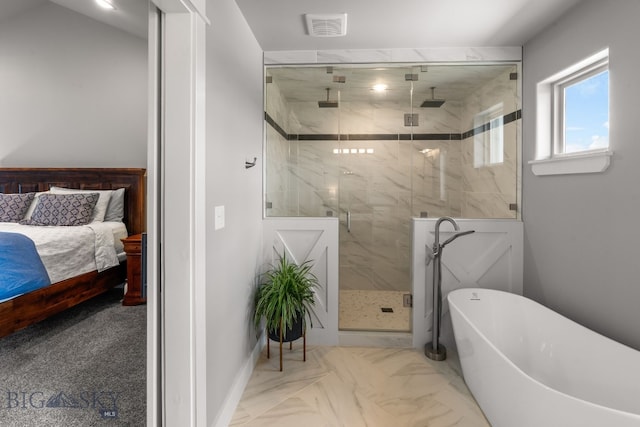 85 Riparian Way, Bozeman, MT 59718 - ensuite bathroom with a marble finish shower, a freestanding bath, and marble finish flooring