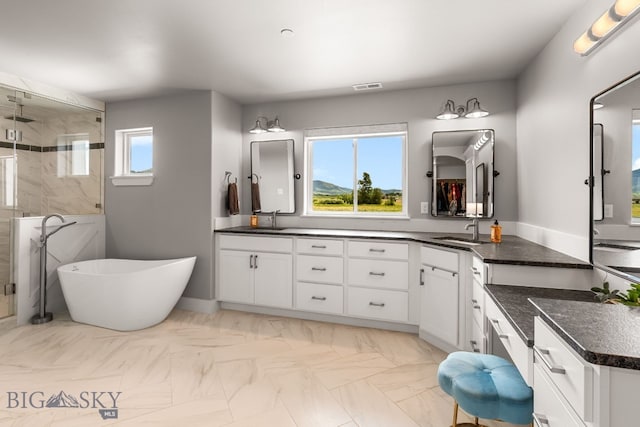 85 Riparian Way, Bozeman, MT 59718 - full bath with a stall shower, double vanity, and a soaking tub