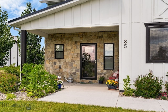 85 Riparian Way, Bozeman, MT 59718 - doorway to property with board and batten siding and stone siding