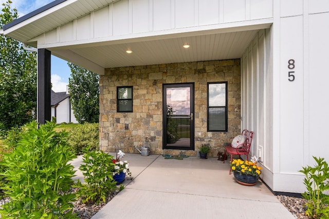85 Riparian Way, Bozeman, MT 59718 - view of exterior entry featuring stone siding, board and batten siding, and a patio