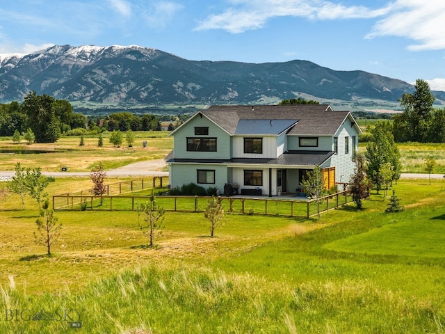 85 Riparian Way, Bozeman, MT 59718 - view of front facade featuring a mountain view, a metal roof, a view of countryside, and board and batten siding