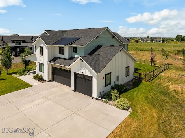 85 Riparian Way, Bozeman, MT 59718 - modern inspired farmhouse featuring board and batten siding, a shingled roof, driveway, and an attached garage