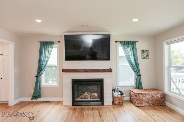 717 N Aster Ave, Bozeman, MT 59718 - living room with wood finished floors, plenty of natural light, a large fireplace, and recessed lighting