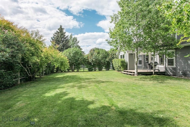 717 N Aster Ave, Bozeman, MT 59718 - view of grassy yard featuring a deck