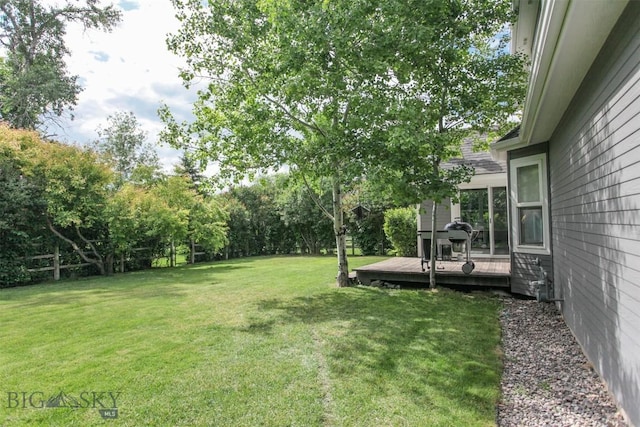 717 N Aster Ave, Bozeman, MT 59718 - view of grassy yard with a deck and view of scattered trees