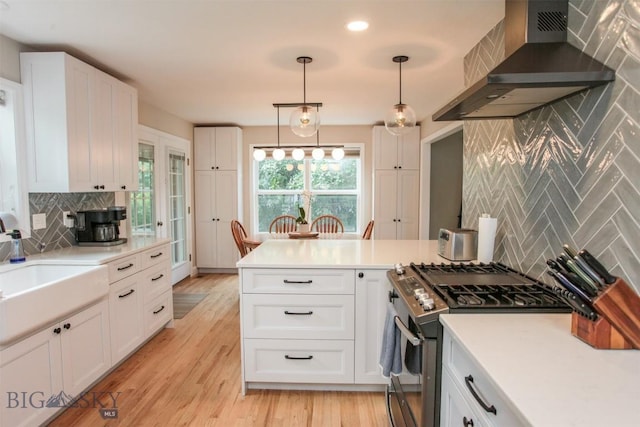 717 N Aster Ave, Bozeman, MT 59718 - kitchen featuring range hood, stainless steel gas range oven, backsplash, white cabinetry, and recessed lighting