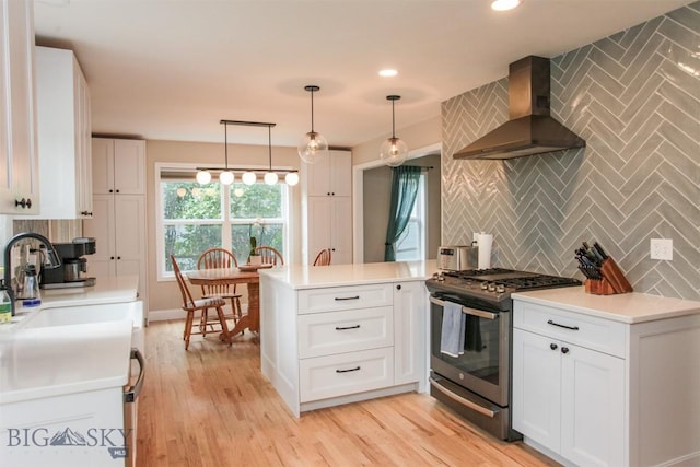 717 N Aster Ave, Bozeman, MT 59718 - kitchen with stainless steel gas stove, wall chimney exhaust hood, decorative backsplash, a peninsula, and recessed lighting