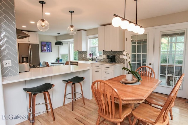 717 N Aster Ave, Bozeman, MT 59718 - kitchen featuring appliances with stainless steel finishes, backsplash, light wood-style flooring, white cabinetry, and recessed lighting