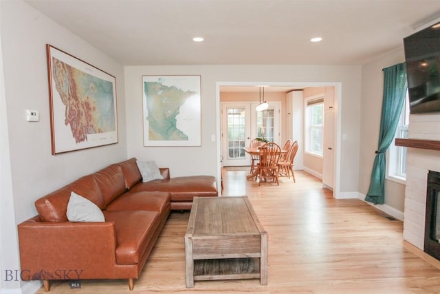 717 N Aster Ave, Bozeman, MT 59718 - living area featuring light wood finished floors, a fireplace, and recessed lighting