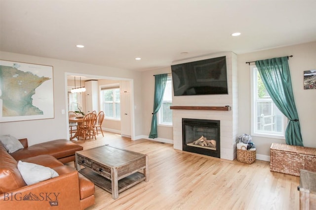 717 N Aster Ave, Bozeman, MT 59718 - living area featuring wood finished floors, healthy amount of natural light, recessed lighting, and a large fireplace