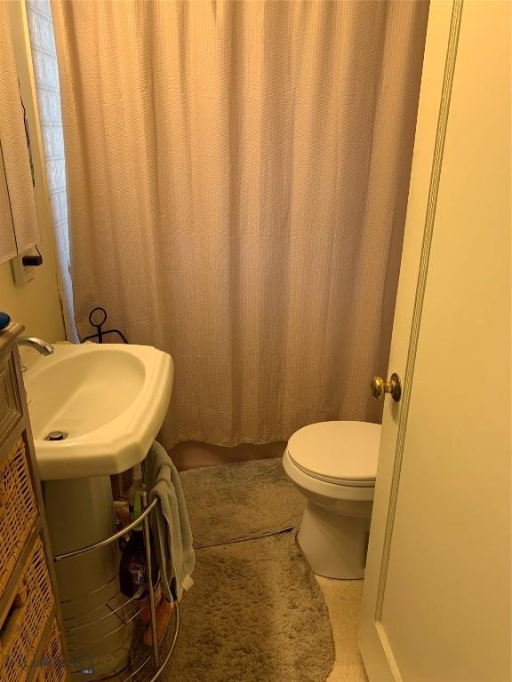 2320 S S Dr, Butte, MT 59701 - bathroom featuring toilet and curtained shower