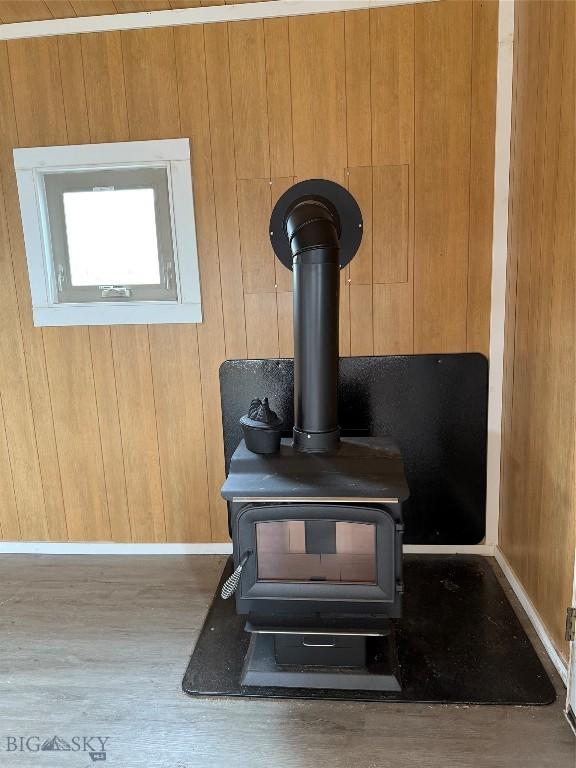 357 Pole Gulch Rd, Three Forks, MT 59752 - detailed view of a wood stove, wooden walls, and wood finished floors