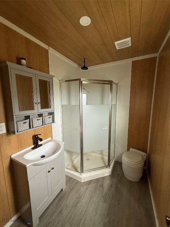 357 Pole Gulch Rd, Three Forks, MT 59752 - bathroom with wood ceiling, a shower stall, vanity, wood finished floors, and wooden walls