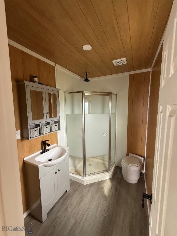 357 Pole Gulch Rd, Three Forks, MT 59752 - bathroom featuring wooden ceiling, a shower stall, vanity, and wood finished floors