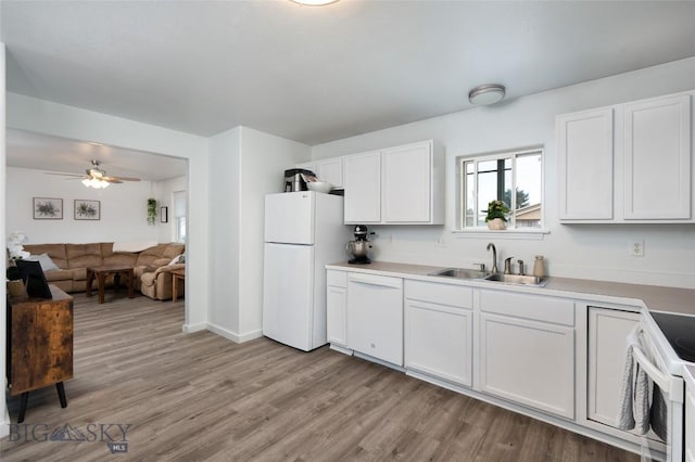 208 Show Pl Unit A, Belgrade, MT 59714 - kitchen with white appliances, light wood-style flooring, white cabinetry, ceiling fan, and open floor plan