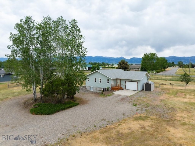 1680 Remuda Dr, Belgrade, MT 59714 - view of front of property featuring gravel driveway, a mountain view, and a garage
