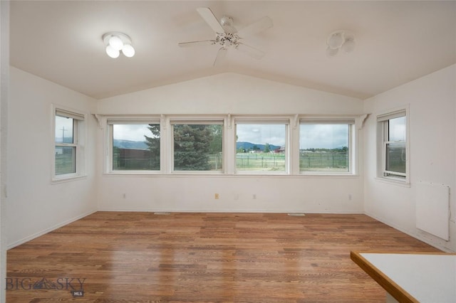 1680 Remuda Dr, Belgrade, MT 59714 - unfurnished room featuring lofted ceiling, ceiling fan, and wood finished floors