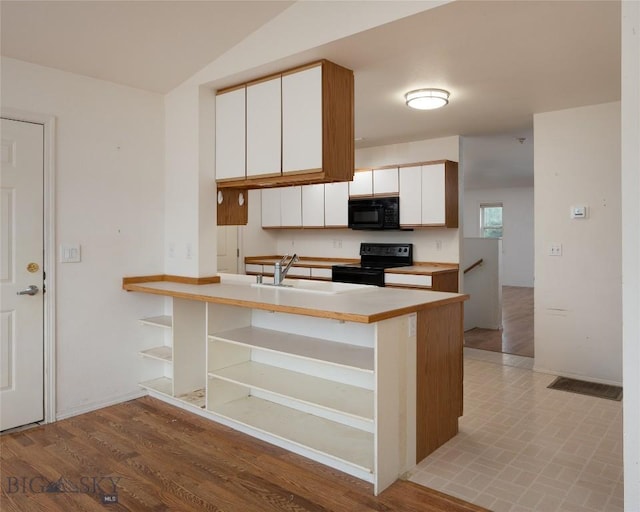1680 Remuda Dr, Belgrade, MT 59714 - kitchen with black appliances, open shelves, white cabinets, light countertops, and a peninsula