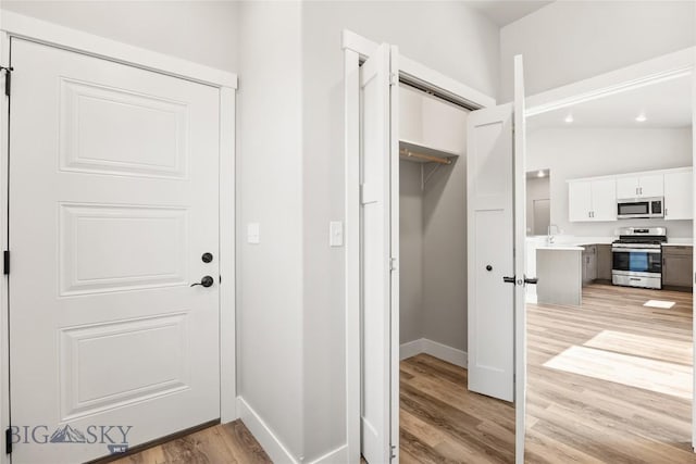 3815 S Arizona, Butte, MT 59701 - doorway to outside with light wood finished floors and vaulted ceiling