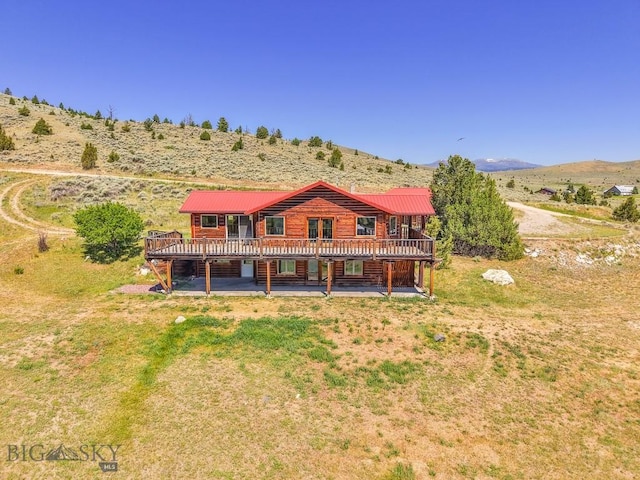 2 Eight Mile Creek Rd, Ennis, MT 59729 - rear view of house with a deck with mountain view, a patio area, and log veneer siding