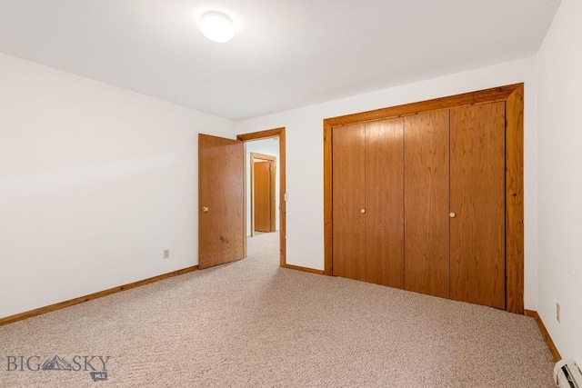 2 Eight Mile Creek Rd, Ennis, MT 59729 - unfurnished bedroom with light carpet, a baseboard heating unit, and a closet