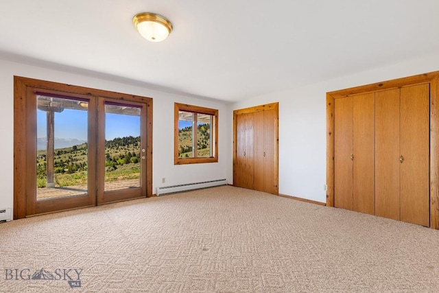 2 Eight Mile Creek Rd, Ennis, MT 59729 - unfurnished bedroom with a baseboard radiator, access to outside, multiple windows, and carpet