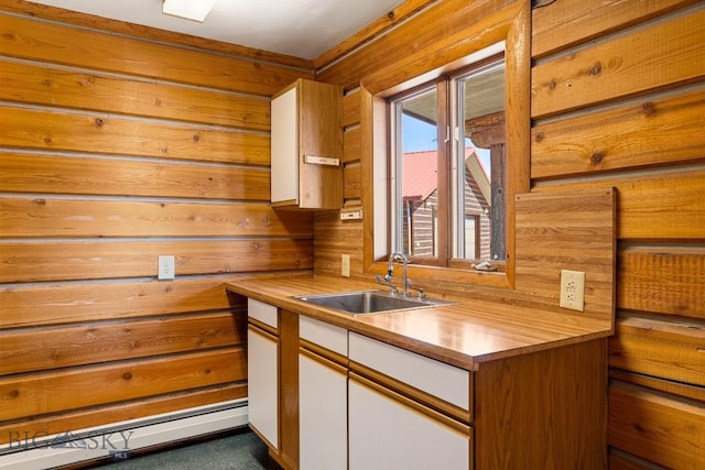 2 Eight Mile Creek Rd, Ennis, MT 59729 - kitchen featuring white cabinetry, a baseboard heating unit, wooden walls, and butcher block counters