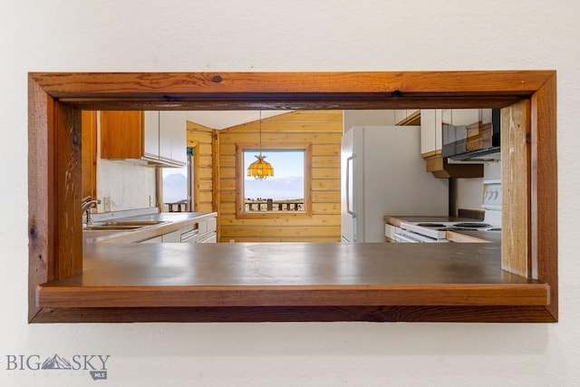 2 Eight Mile Creek Rd, Ennis, MT 59729 - kitchen view of white appliances, pendant lighting, and wooden walls